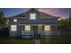 Charming two-story home with a welcoming front porch and manicured lawn, perfect for relaxation at 1048 W Lime St, Lakeland, FL 33815