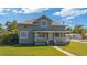 Inviting two-story home with a classic porch and well-maintained grassy front yard at 1048 W Lime St, Lakeland, FL 33815