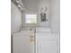 Functional laundry area with a washer, dryer, wire shelving and a window for natural light at 1048 W Lime St, Lakeland, FL 33815