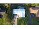 Aerial view showcasing the home's metal roof, backyard, and surrounding lush green landscape at 4041 Se 20Th Ct, Ocala, FL 34480