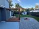 Backyard featuring a wooden patio, a firepit, neutral gravel, and mature trees at 4041 Se 20Th Ct, Ocala, FL 34480