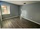 Grey bedroom featuring hardwood floors, natural light, and neutral paint, creating a calming atmosphere at 4041 Se 20Th Ct, Ocala, FL 34480