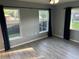 Bedroom showcasing hardwood floors, ample natural light through large windows, and modern curtains at 4041 Se 20Th Ct, Ocala, FL 34480