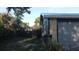 Exterior of home showing stone detail, gray garage door, manicured landscaping, and a privacy fence at 4041 Se 20Th Ct, Ocala, FL 34480