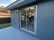 Home exterior showcasing a view through a sliding glass door to the interior dining room and kitchen at 4041 Se 20Th Ct, Ocala, FL 34480