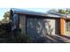 Attached garage with gray door, natural stone accents, and freshly paved driveway at 4041 Se 20Th Ct, Ocala, FL 34480
