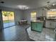 Modern kitchen featuring stainless steel appliances, an island, a dining area, and sliding glass doors at 4041 Se 20Th Ct, Ocala, FL 34480