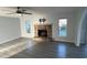Spacious living room with a stone fireplace, ample natural light, and hardwood-style flooring at 4041 Se 20Th Ct, Ocala, FL 34480