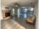 Open-concept living room with a stone fireplace, tile floors, and views into the updated kitchen at 4041 Se 20Th Ct, Ocala, FL 34480