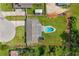 Aerial view showing the house, pool, and large grassy yard surrounded by trees at 5324 Messina, Lakeland, FL 33813