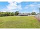 Expansive backyard featuring a pool, trampoline, green grass and a privacy fence at 5324 Messina, Lakeland, FL 33813