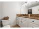 Bathroom featuring white cabinets, granite countertops, a mirror, and modern toilet at 5324 Messina, Lakeland, FL 33813