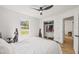 Bright bedroom with a ceiling fan, large window, walk-in closet, and light hardwood floors at 5324 Messina, Lakeland, FL 33813