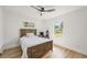 Bedroom with a rustic wooden bed frame, ceiling fan, and natural light at 5324 Messina, Lakeland, FL 33813