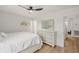 Well-lit bedroom featuring a dresser with mirror, light-colored walls, and wood-look flooring at 5324 Messina, Lakeland, FL 33813