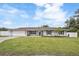 Charming single-story home with a manicured lawn, fresh flowers, and a classic American flag at 5324 Messina, Lakeland, FL 33813
