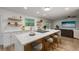 Open-concept kitchen with a large island, bar stool seating, and hardwood floors at 5324 Messina, Lakeland, FL 33813