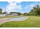 Beautifully maintained pool in a spacious backyard with lush green grass and blue skies at 5324 Messina, Lakeland, FL 33813