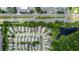 Aerial view of a neighborhood near a pond with commercial development nearby at 643 Blenheim Loop, Winter Springs, FL 32708
