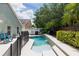Backyard pool with a spa featuring patio furniture, privacy fence, and mature landscaping at 643 Blenheim Loop, Winter Springs, FL 32708