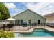 Backyard pool with a black fence, outdoor seating area, and a well-maintained patio at 643 Blenheim Loop, Winter Springs, FL 32708
