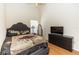 Bedroom featuring wood floors, a bed, dresser and oval mirror at 643 Blenheim Loop, Winter Springs, FL 32708