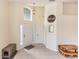 Welcoming foyer featuring tile flooring, a decorative mirror, and a charming pendant light fixture at 643 Blenheim Loop, Winter Springs, FL 32708