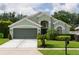 Charming home featuring a well-manicured lawn, an attached two-car garage, and inviting curb appeal at 643 Blenheim Loop, Winter Springs, FL 32708