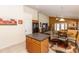 Features light wood cabinets, black appliances, an island with bar seating, and tile floors at 643 Blenheim Loop, Winter Springs, FL 32708