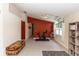 Bright living room with a red accent wall, tile floors, and natural light at 643 Blenheim Loop, Winter Springs, FL 32708