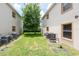 View of the backyard with lush green lawn, trees and the exterior of the units at 946 15Th St # 202, Daytona Beach, FL 32117