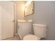 Bathroom with a white vanity, a framed mirror, a toilet, and a white door at 946 15Th St # 202, Daytona Beach, FL 32117