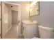 Bathroom featuring a white vanity with a framed mirror and a toilet at 946 15Th St # 202, Daytona Beach, FL 32117