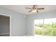 Well-lit bedroom featuring ceiling fan and sliding glass door to balcony at 946 15Th St # 202, Daytona Beach, FL 32117