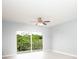 Well-lit bedroom featuring ceiling fan and sliding glass door to balcony at 946 15Th St # 202, Daytona Beach, FL 32117