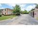 A two-story condo unit featuring well-maintained landscaping and an expansive parking area on a sunny day at 946 15Th St # 202, Daytona Beach, FL 32117