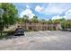 Exterior of the condo featuring multiple balconies, palm trees, and convenient parking spaces for residents and guests at 946 15Th St # 202, Daytona Beach, FL 32117