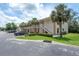 Condo building featuring palm trees, green space, and outdoor parking at 946 15Th St # 202, Daytona Beach, FL 32117