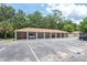 Covered parking with a white vehicle parked under a canopy, surrounded by trees at 946 15Th St # 202, Daytona Beach, FL 32117