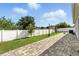 Spacious backyard with a brick patio and a white fence, great for outdoor entertaining at 303 Briarbrook Ln, Haines City, FL 33844