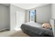 This secondary bedroom features natural light, a closet, and neutral decor at 303 Briarbrook Ln, Haines City, FL 33844