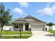 Charming single-story home with well-maintained lawn and two-car garage at 303 Briarbrook Ln, Haines City, FL 33844