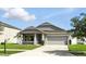 Lovely single-story home with a two-car garage and well manicured lawn at 303 Briarbrook Ln, Haines City, FL 33844