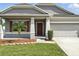 Charming home with a well-manicured lawn and a two-car garage, showcasing curb appeal at 303 Briarbrook Ln, Haines City, FL 33844