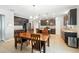 Open kitchen with dark wood cabinetry, stainless steel appliances, and a central island at 303 Briarbrook Ln, Haines City, FL 33844
