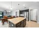 Modern kitchen featuring a large center island with seating and stainless steel refrigerator at 303 Briarbrook Ln, Haines City, FL 33844