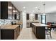 Well-equipped kitchen with sleek cabinetry, stainless steel appliances, and a functional center island at 303 Briarbrook Ln, Haines City, FL 33844