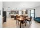 Modern kitchen and dining area featuring dark cabinets, stainless appliances, and tiled backsplash at 303 Briarbrook Ln, Haines City, FL 33844