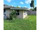 The backyard is spacious and overgrown with lots of potential at 5455 Pinetrail Way, Orlando, FL 32822