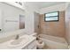 Bathroom with a bathtub, ceramic tile, sink, vanity, and a flower-print toilet seat at 5455 Pinetrail Way, Orlando, FL 32822
